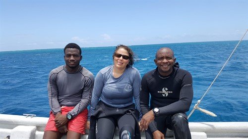 Picture of three members of the Green Fins Antigua & Barbuda team on a boat. 