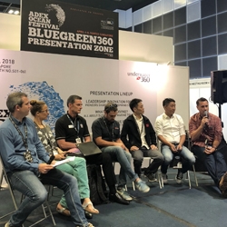 Picture of a panel of speakers on stage in the BlueGreen360 Presentation Zone at ADEX Singapore. 