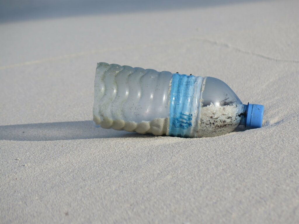 Picture of a plastic bottle on a beach. 