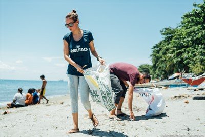 Picture of volunteers collecting trash during a beach clean-up event. 