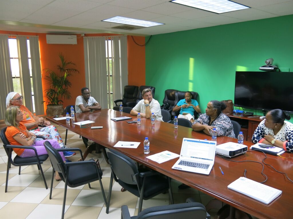 Picture of people sitting around a table at the meeting between Reef-World and the Department of Fisheries in Antigua & Barbuda. 