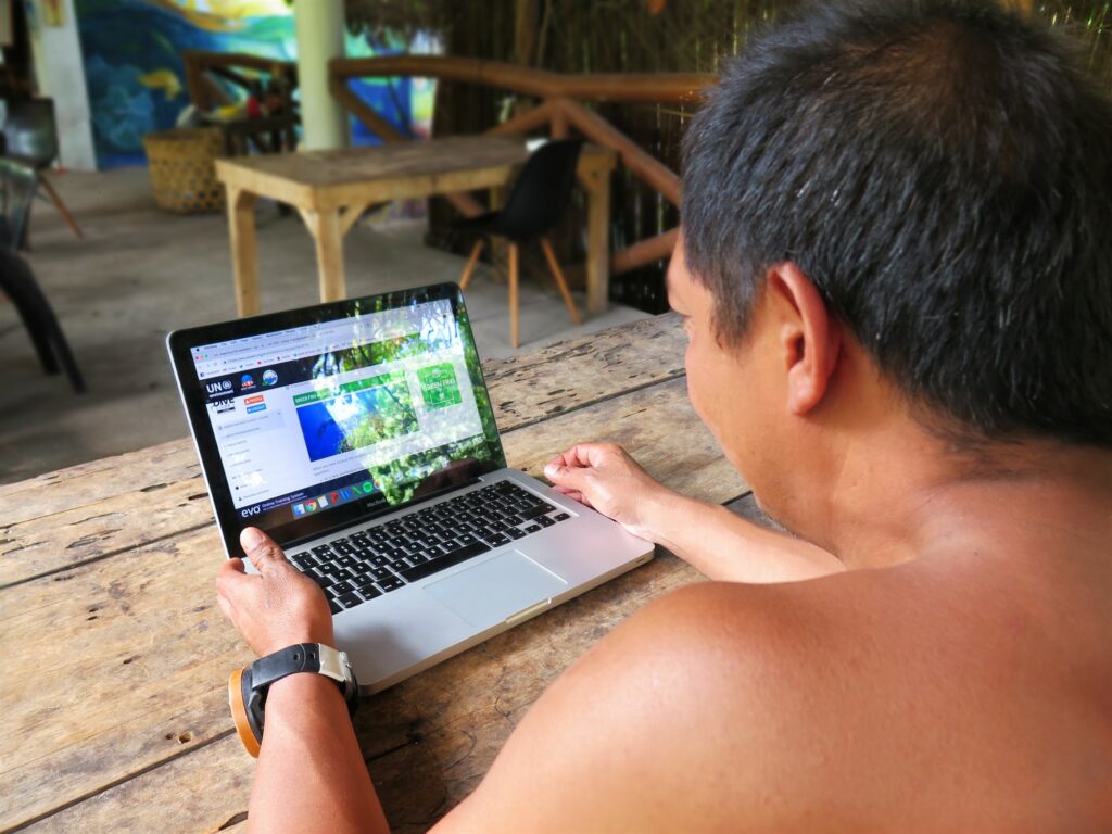 Picture of a person looking at the Green Fins Dive Guide e-Course on a laptop. 