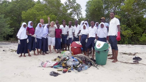 Picture of Furaha's beach cleaning team with the they trash collected. 