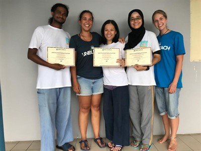 Photo of Samantha Craven and Melissa Hobson (Reef-World) presenting Alvin, Sue and Ira (Reef Check Malaysia) with their certificates to certify them as qualified assessor trainers