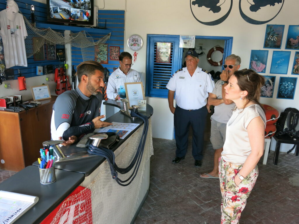 Picture of Reef-World team talking with dive shop team in Dominican Republic. 