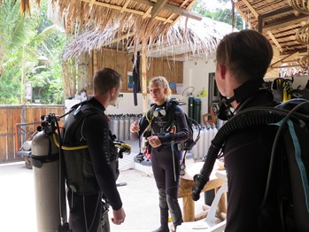 Picture of three SCUBA divers a dive centre. 