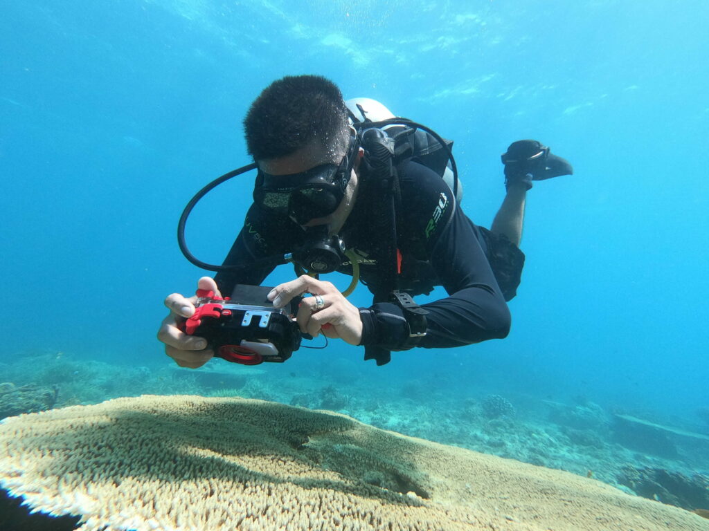 Underwater photographer taking photo