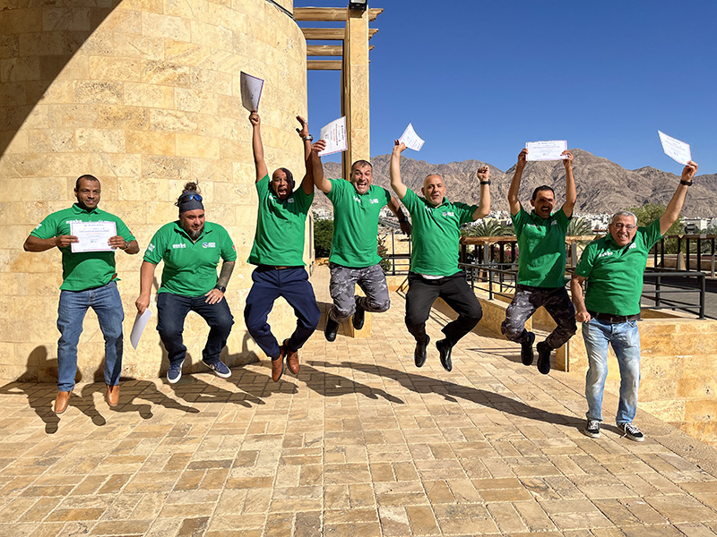 Green Fins Jordan Team jumping with joy on graduation day.