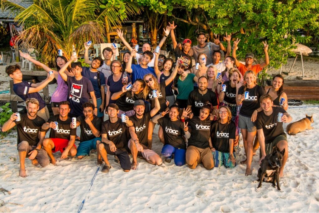 TRACC team and volunteers posing for a group photo on the beach