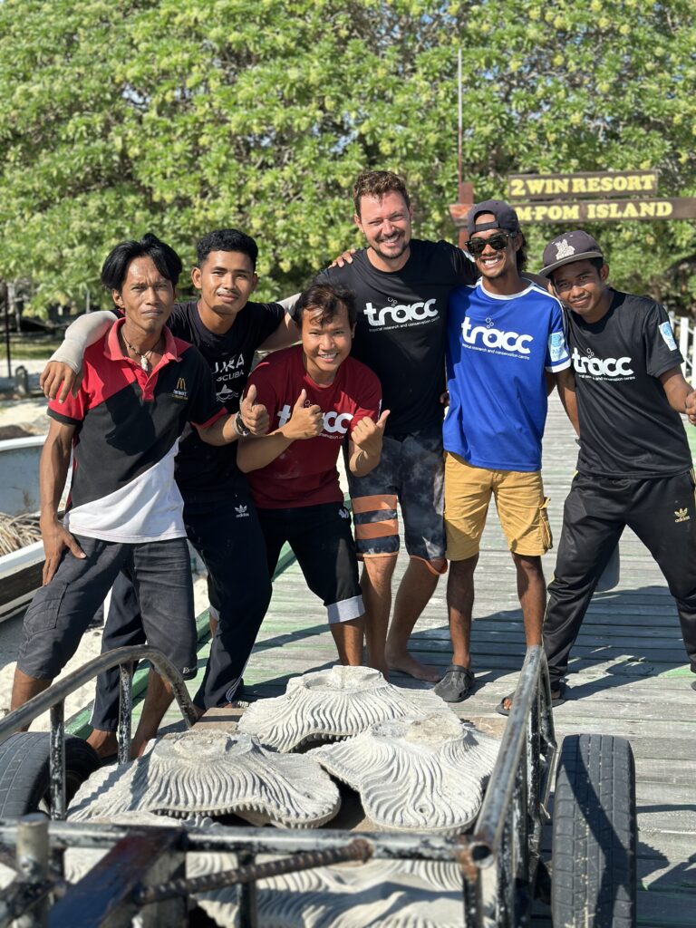 The TRACC team with artificial reef structures on a jetty