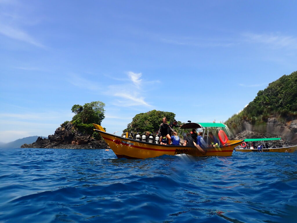 A scuba diving speedboat with divers on the ocean in Malaysia