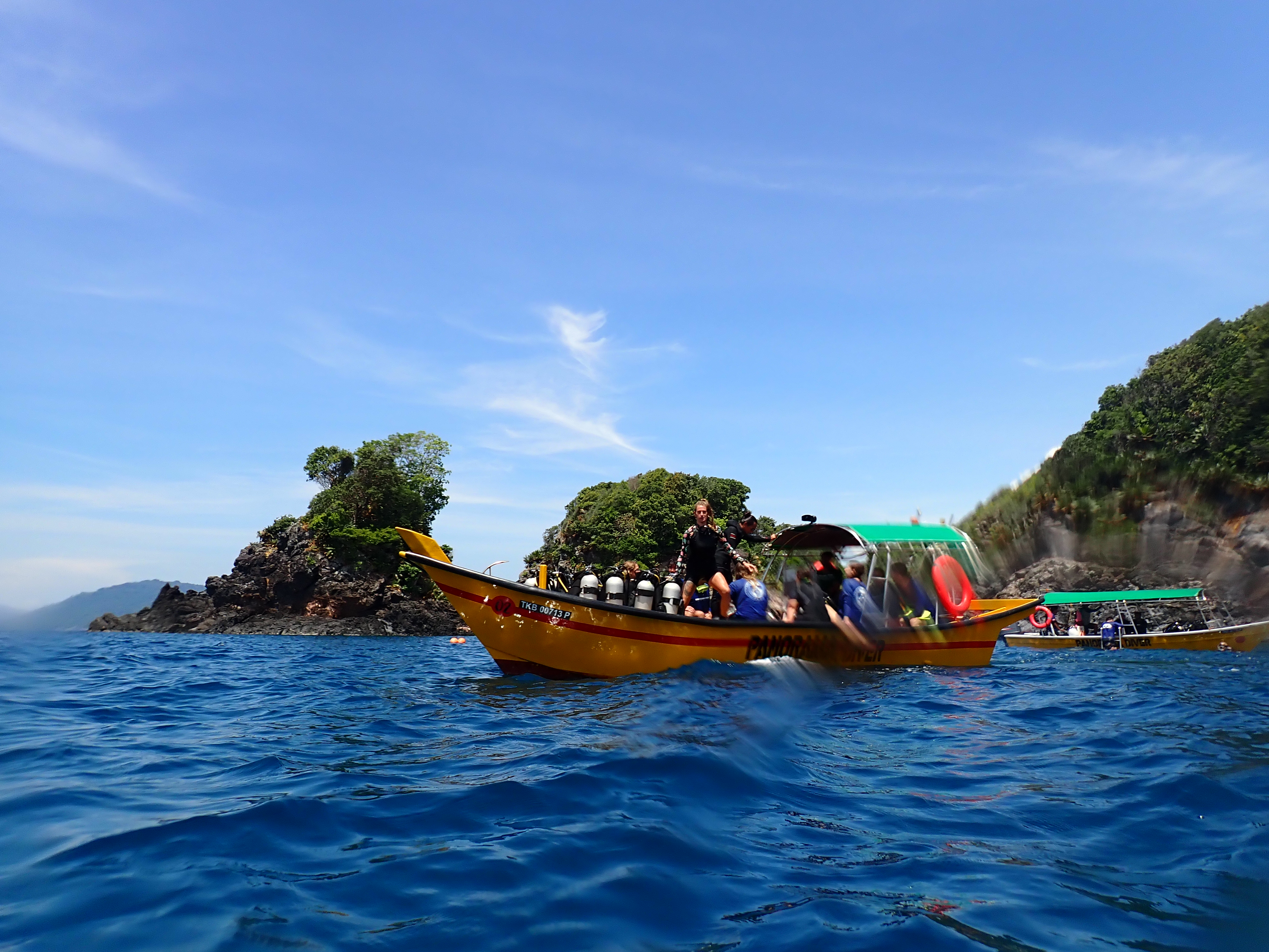 A scuba diving speedboat with divers on the ocean in Malaysia